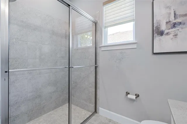 an aerial view of residential houses with outdoor space and ocean view