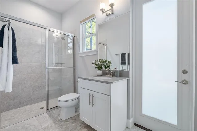 a view of a swimming pool with a yard and large trees