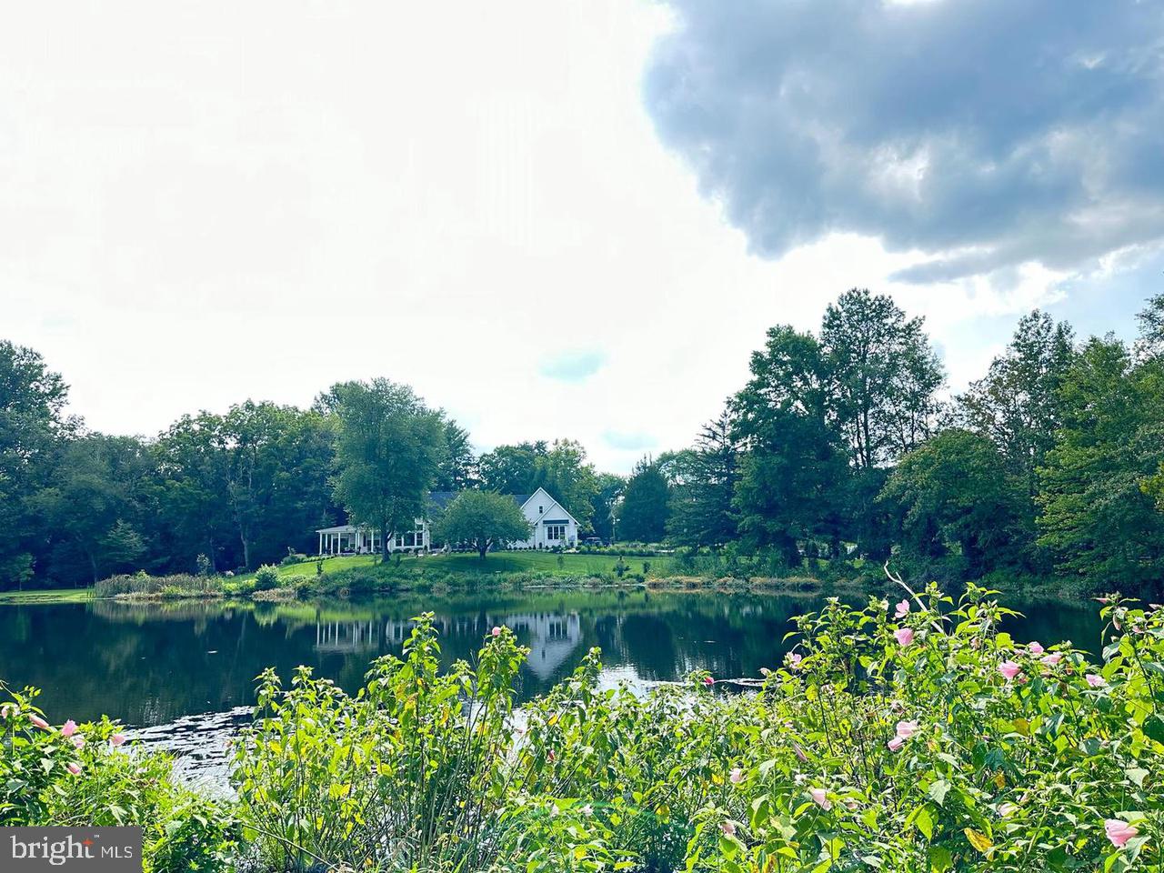 337 Ewan Road Mullica Hill, NJ 08062 - Photo 7 of 23 a view of a lake with a house in the background