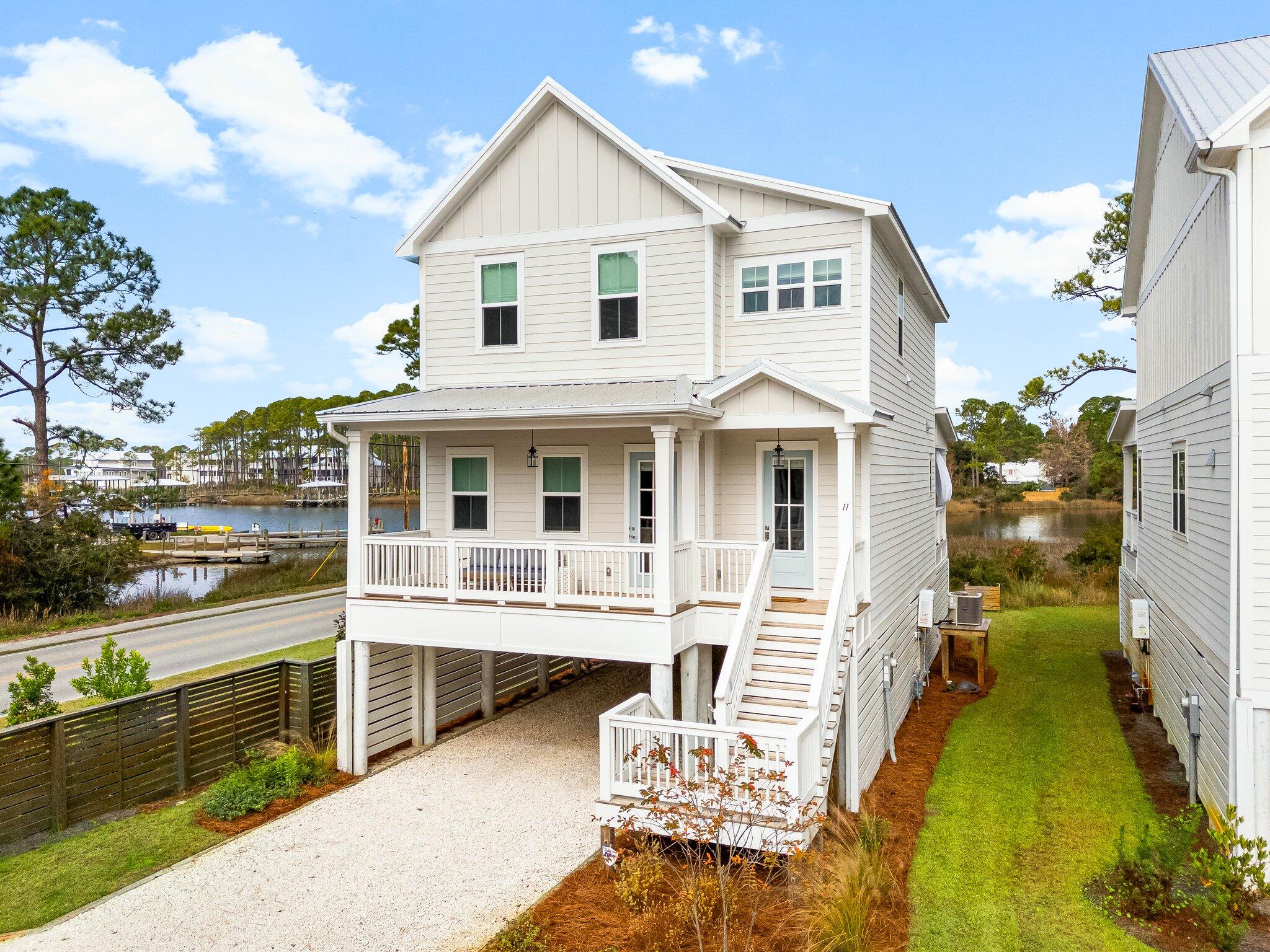 11 Tyler James Way Santa Rosa Beach, FL 32459 - Photo 5 of 56 a front view of a house with a yard table and chairs