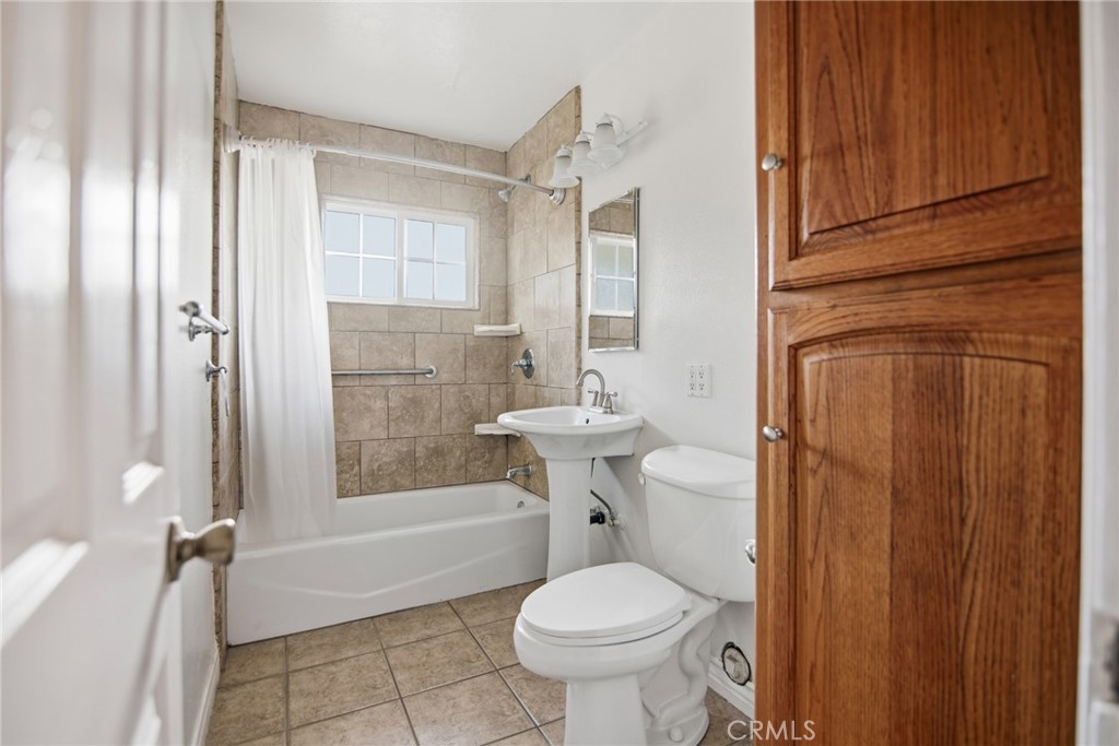 11296 Lampson Avenue Garden Grove, CA 92840 - Photo 16 of 18 a bathroom with a sink toilet and shower