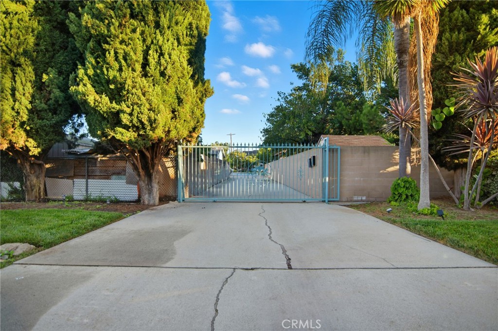 11296 Lampson Avenue Garden Grove, CA 92840 - Photo 3 of 18 front view of a house with a yard and an trees