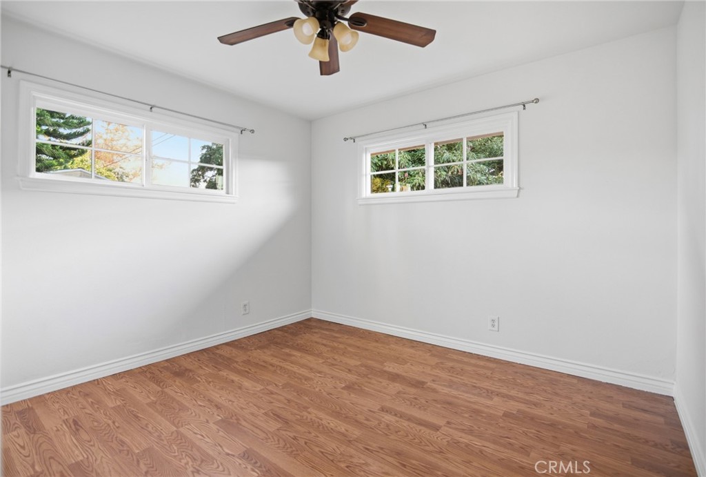 11296 Lampson Avenue Garden Grove, CA 92840 - Photo 10 of 18 a view of a big room with wooden floor and windows