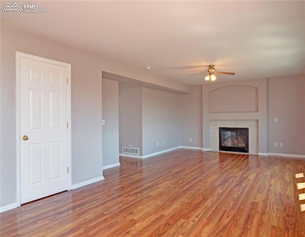7680 Tompkins Road Peyton, CO 80831 - Photo 14 of 30 Family Room with Gas Fireplace. Notice the pantry. Main-bedroom is right around the corner