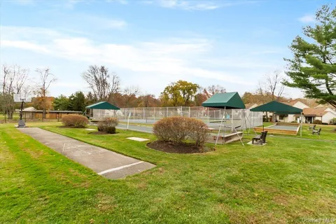 a view of yard with swimming pool and trees in the background