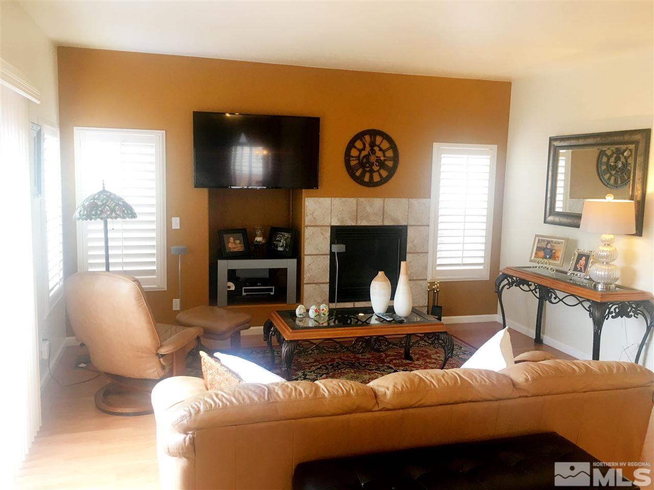 9741 South Legacy Court Reno, NV 89521 - Photo 7 of 19 a living room with furniture and a fireplace
