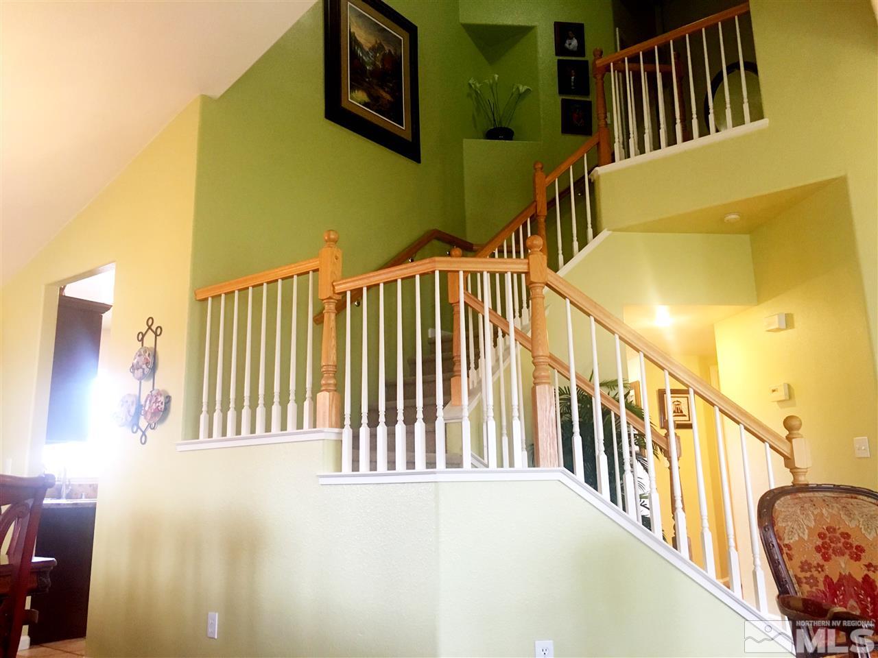 9741 South Legacy Court Reno, NV 89521 - Photo 8 of 19 a view of staircase with lots of frames on wall and a large window