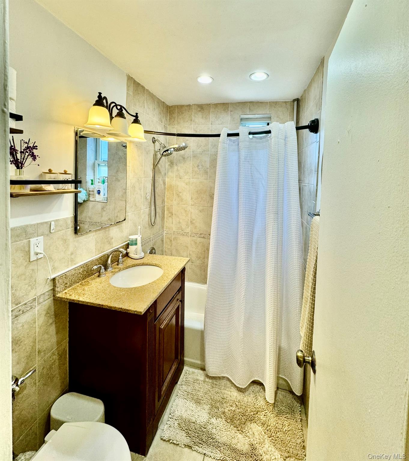 245 Rumsey Road, Unit 6D Yonkers, NY 10701 - Photo 6 of 10 Full bath with vanity, shower / bath combo, and tile walls