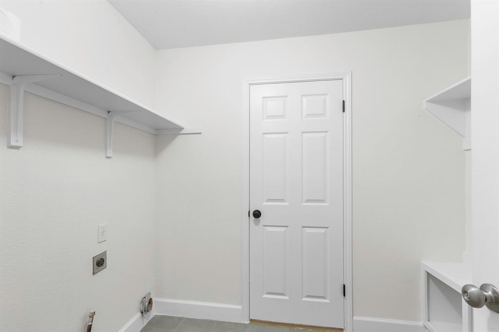 617 Barbara Way Bastrop, TX 78602 - Photo 15 of 20 Functional utility room with ample shelving provides convenient laundry connections and storage solutions.