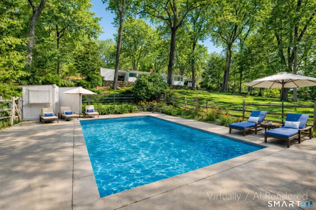 a view of backyard with large trees and plants