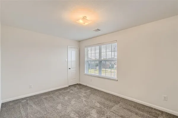 an empty room with a empty space and windows
