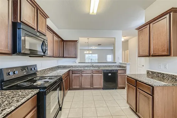 a kitchen with stainless steel appliances granite countertop a sink stove and cabinets
