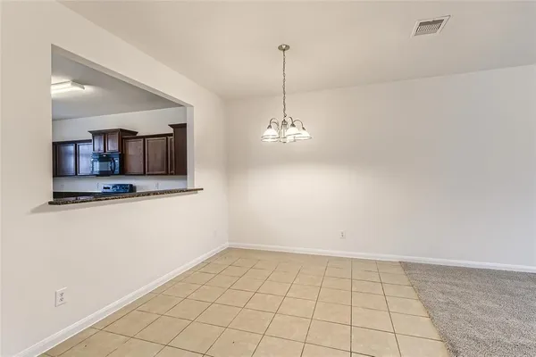 a view of a kitchen with a sink and a chandelier fan