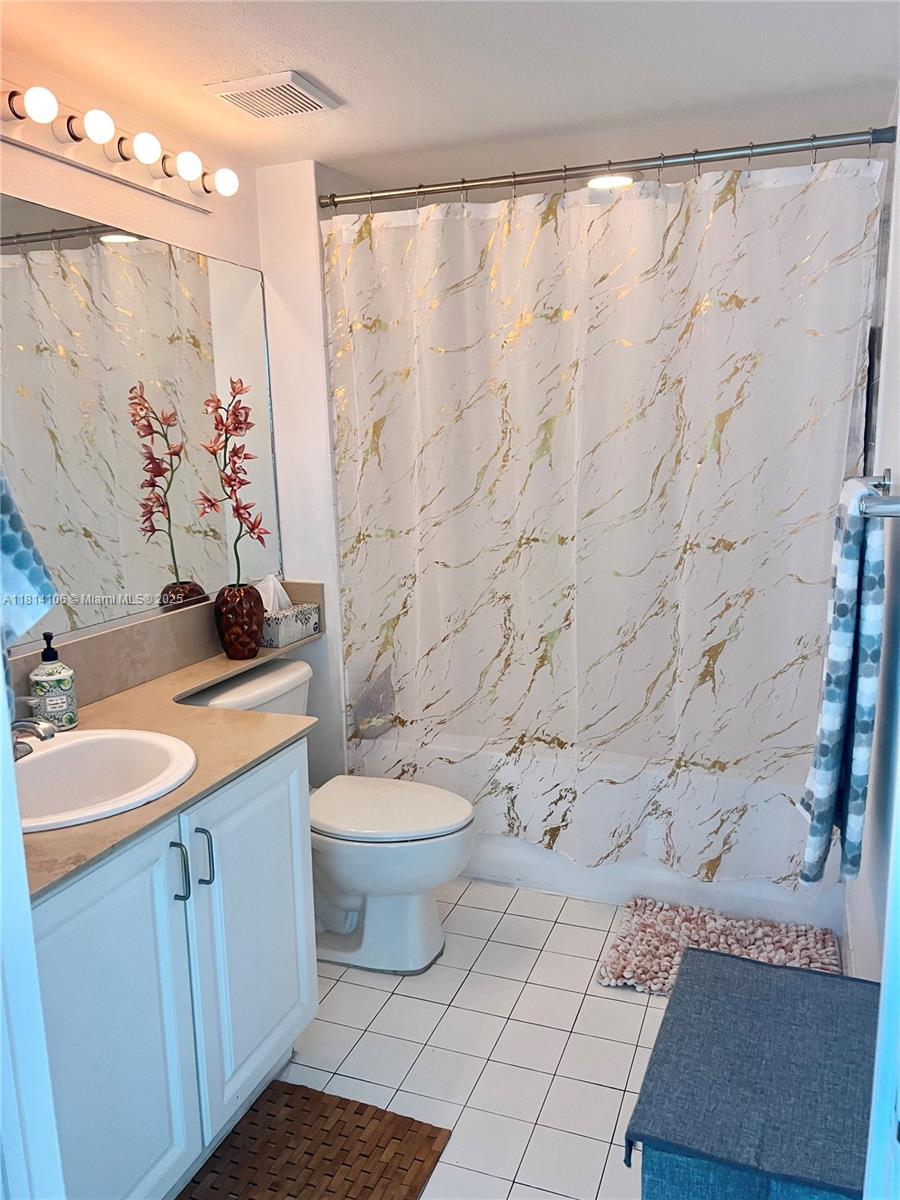 Brickell Miami, FL 33131 - Photo 8 of 25 a bathroom with a granite countertop toilet sink and mirror
