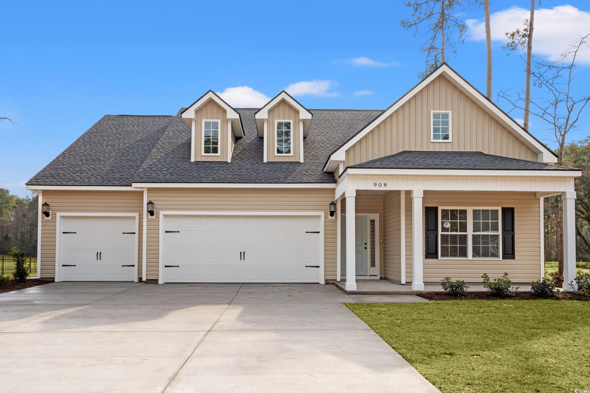 View of front of property with covered porch, a shingled roof, a front yard, concrete driveway, and a garage