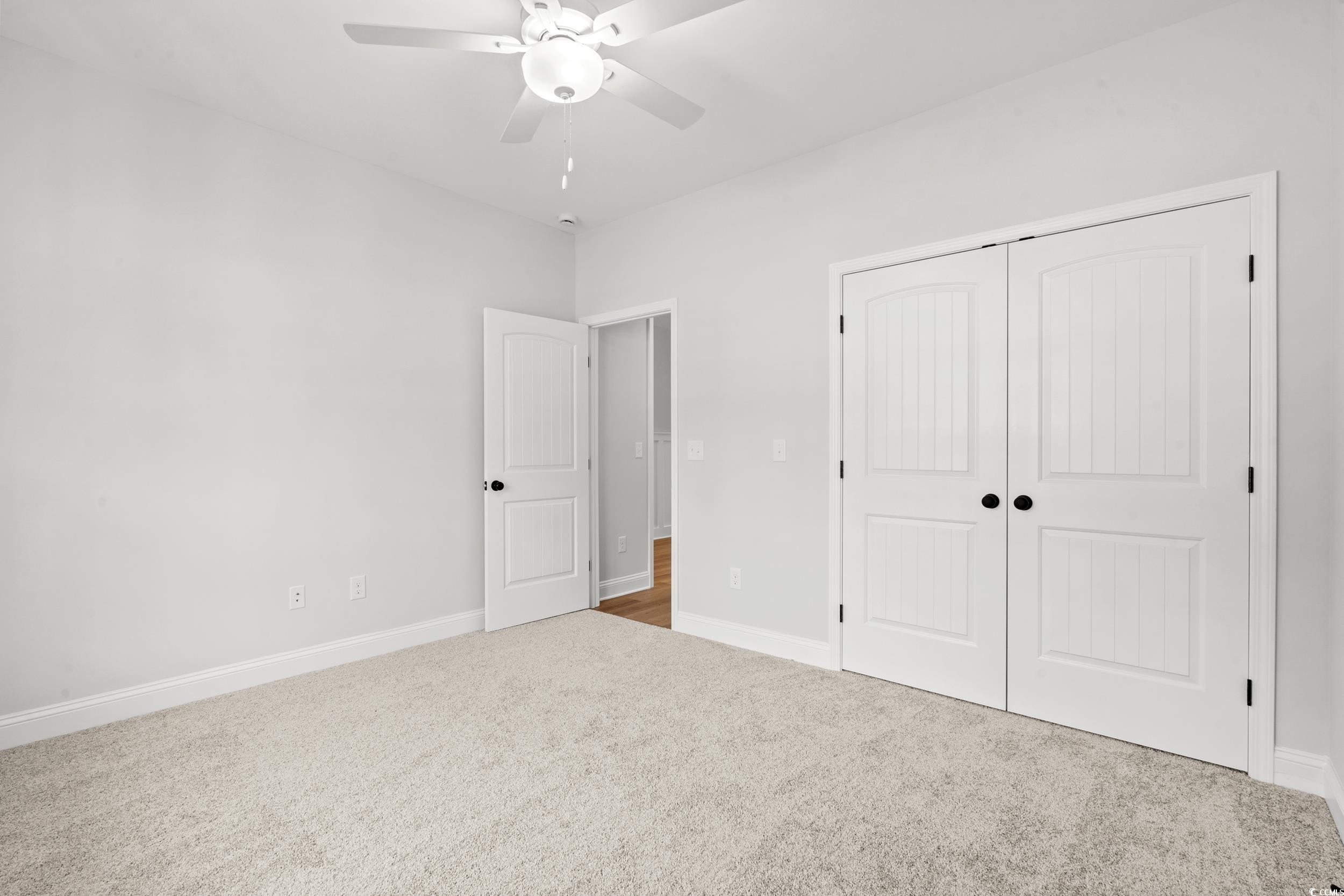 908 Francis Parker Road Georgetown, SC 29440 - Photo 13 of 37 Unfurnished bedroom featuring carpet floors, a closet, and a ceiling fan