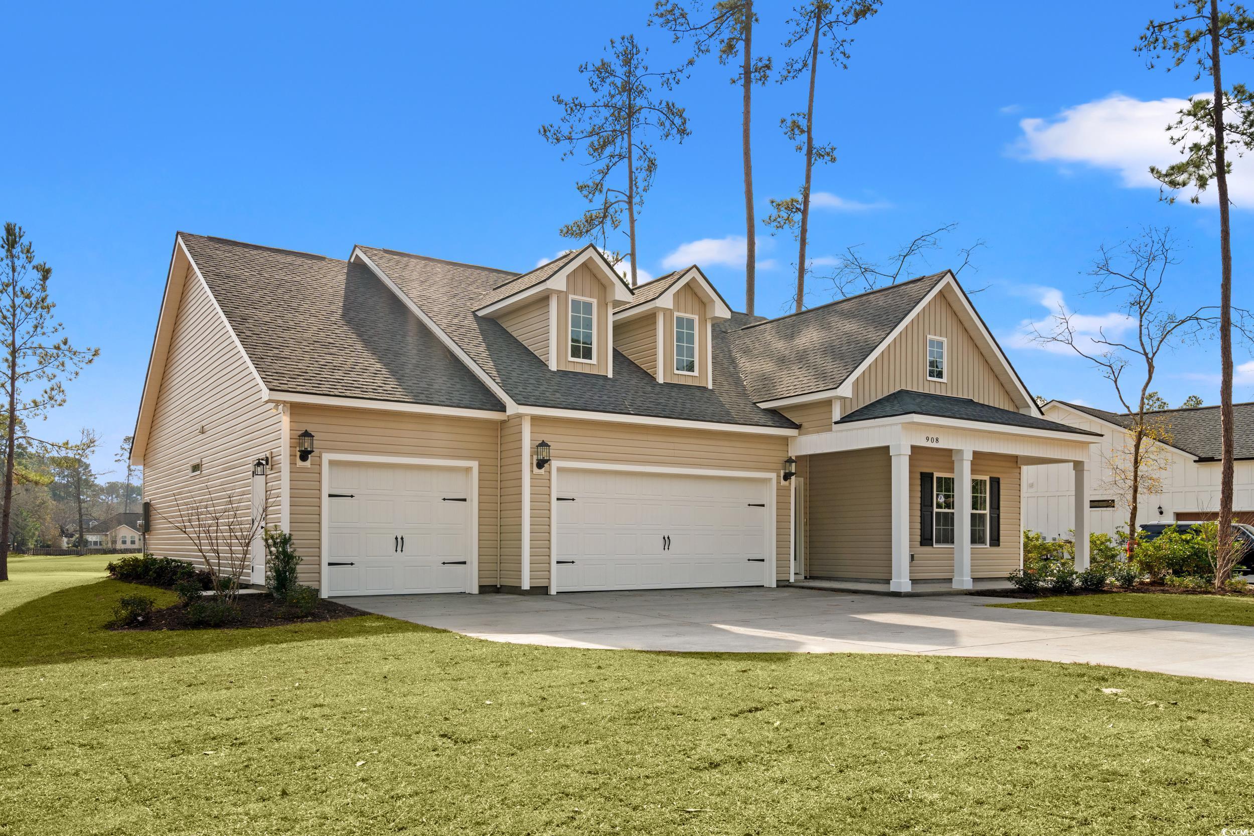 908 Francis Parker Road Georgetown, SC 29440 - Photo 2 of 37 View of front of house with a front yard, roof with shingles, driveway, and a garage