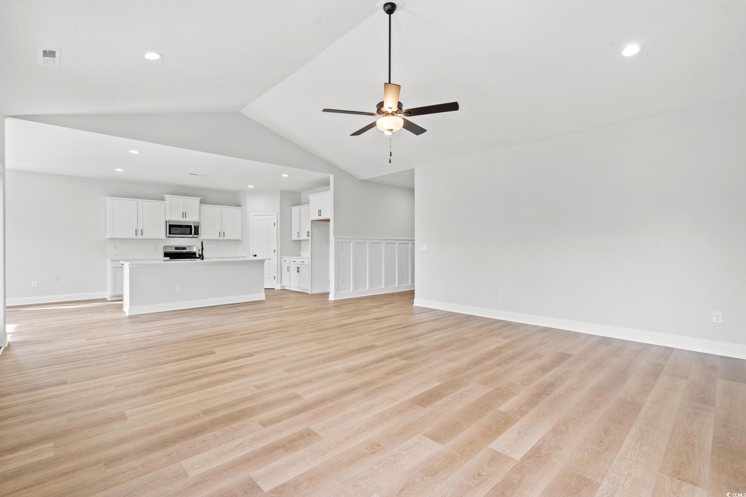 908 Francis Parker Road Georgetown, SC 29440 - Photo 3 of 37 Unfurnished living room featuring light wood-style floors, ceiling fan, vaulted ceiling, and recessed lighting