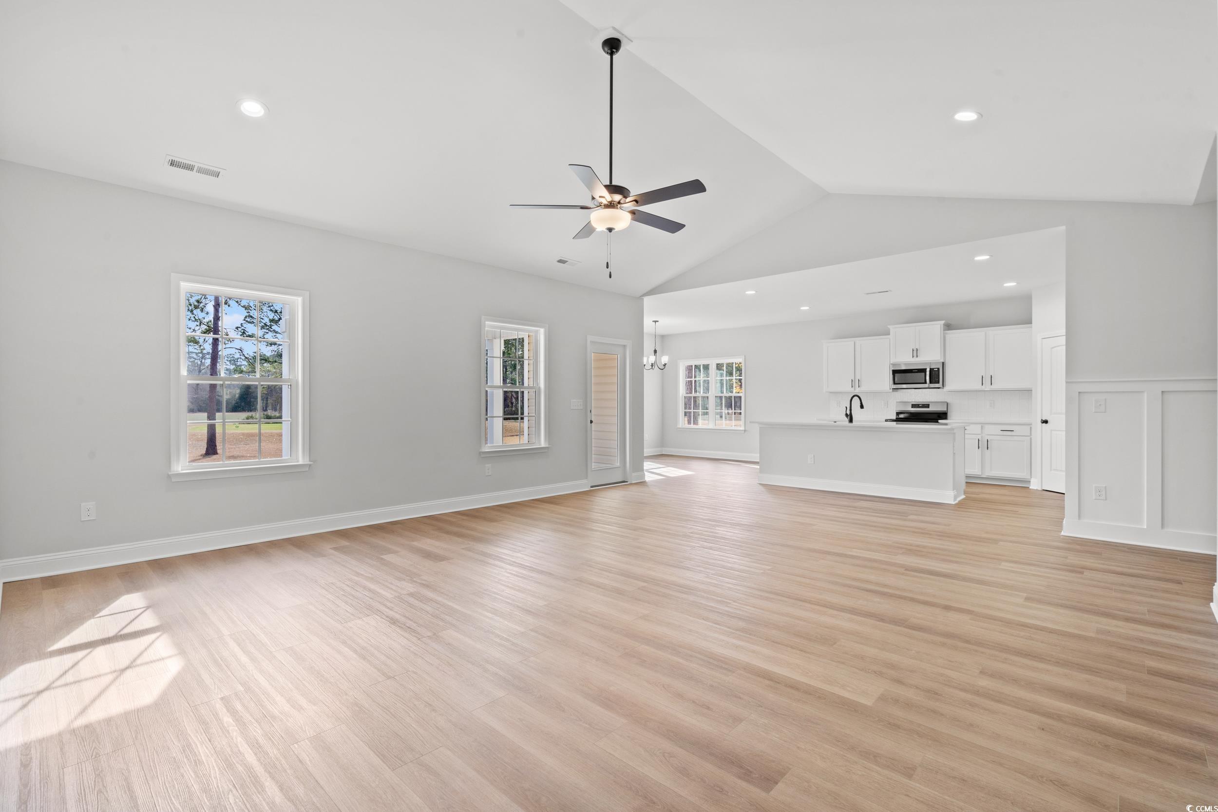 908 Francis Parker Road Georgetown, SC 29440 - Photo 4 of 37 Unfurnished living room featuring light wood finished floors, ceiling fan, lofted ceiling, a chandelier, and recessed lighting