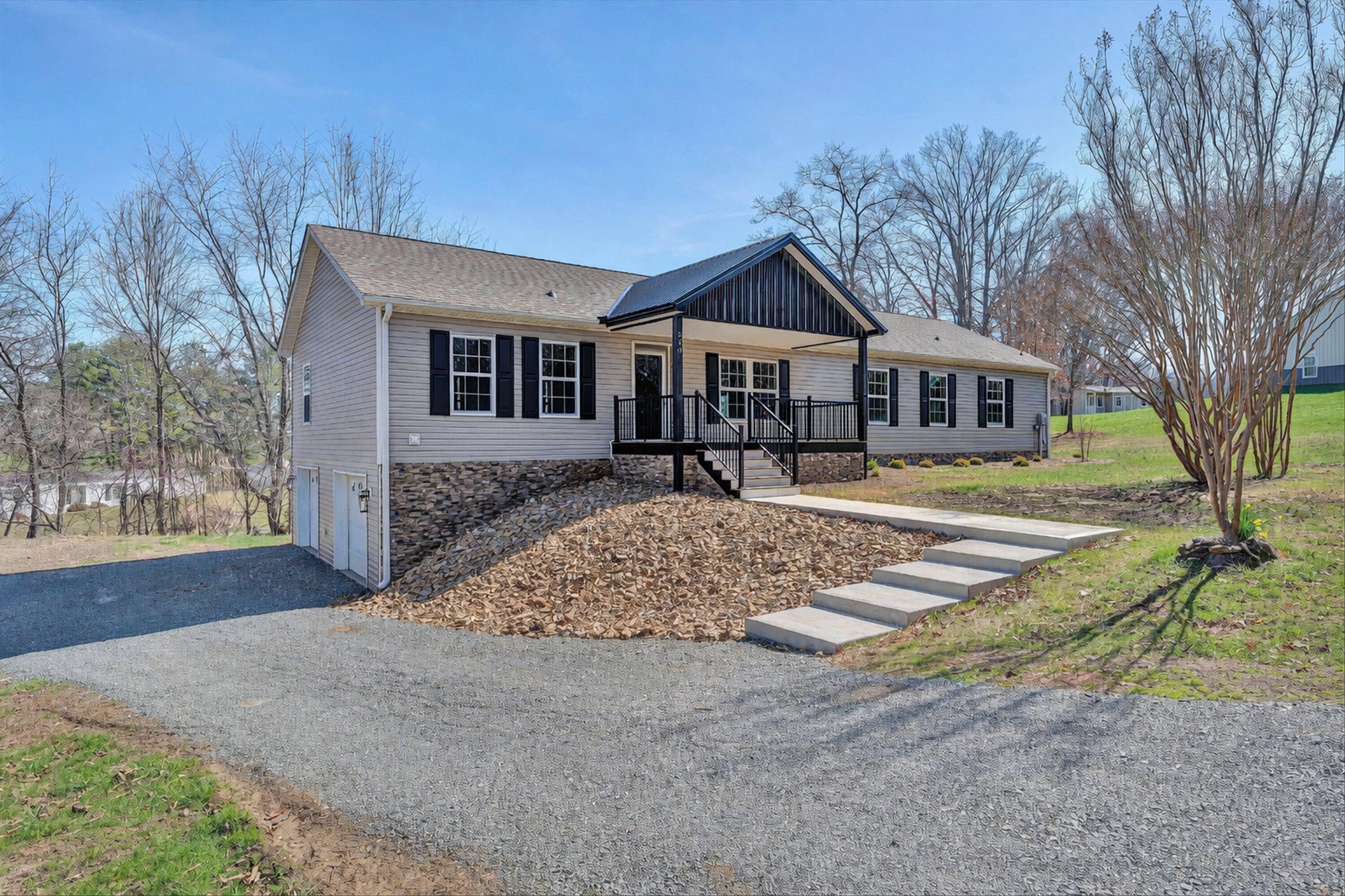 200 Surber Drive Moneta, VA 24121 - Photo 1 of 52 a front view of a house with a yard and garage