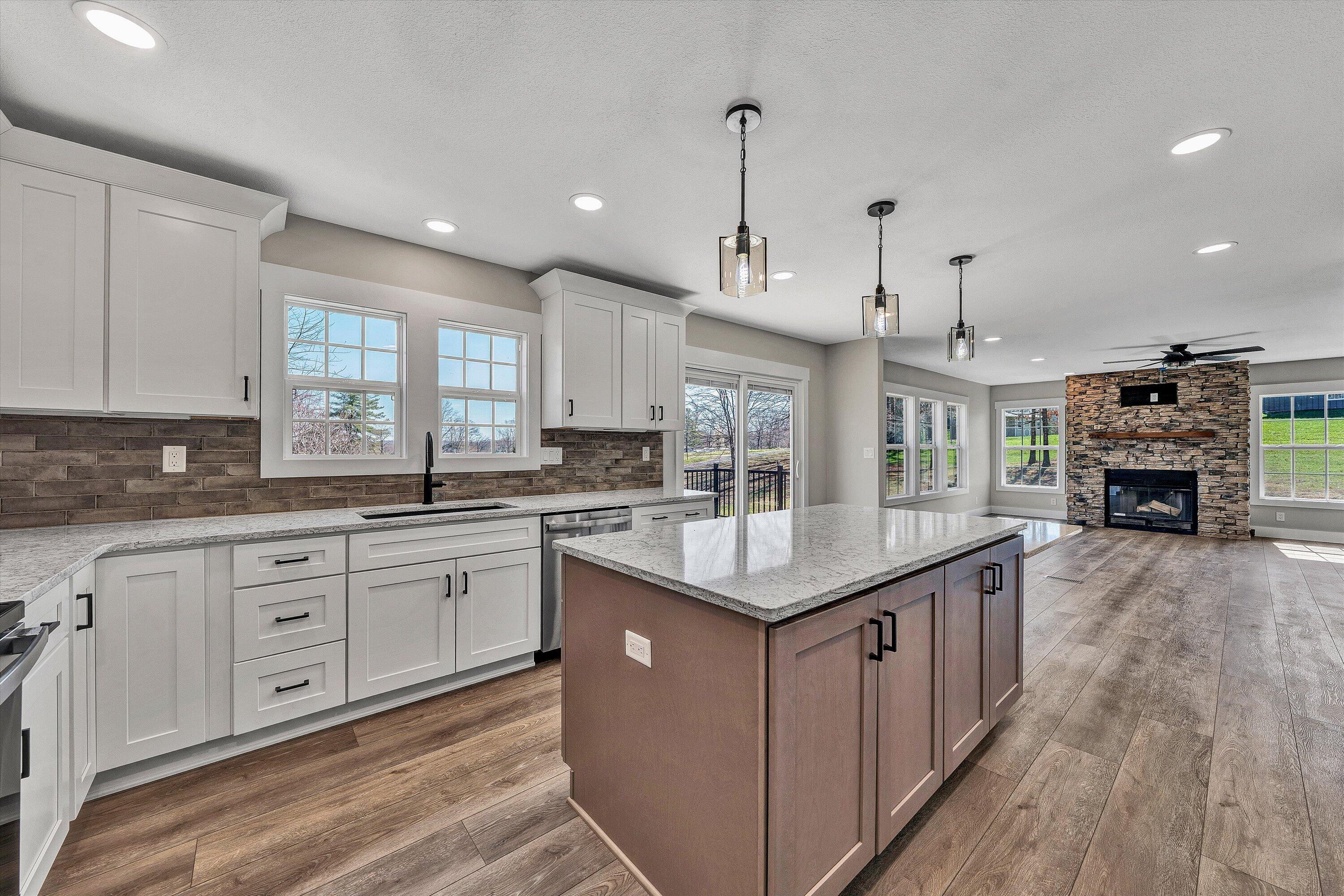 200 Surber Drive Moneta, VA 24121 - Photo 14 of 52 a kitchen with stainless steel appliances granite countertop a sink a stove and a wooden floors