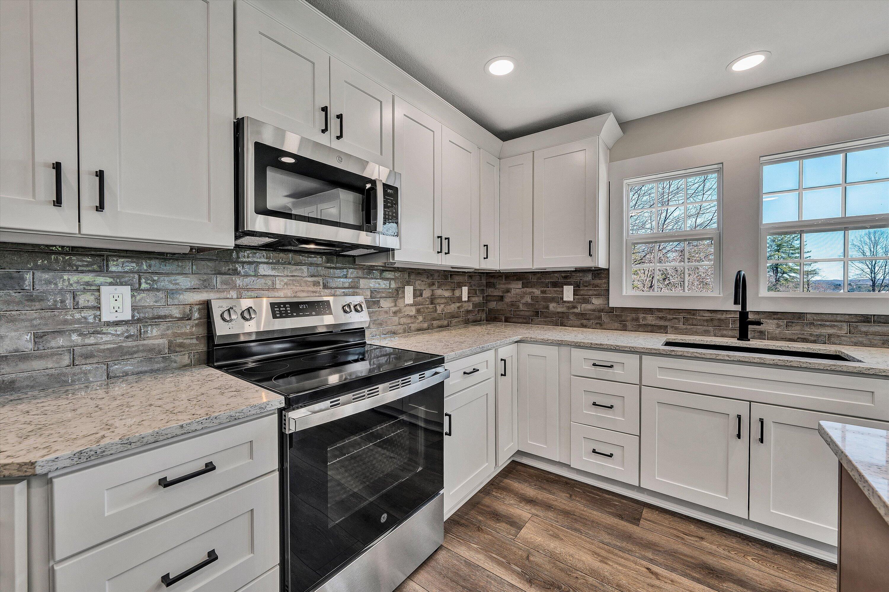 200 Surber Drive Moneta, VA 24121 - Photo 15 of 52 a kitchen with cabinets stainless steel appliances a sink and a stove
