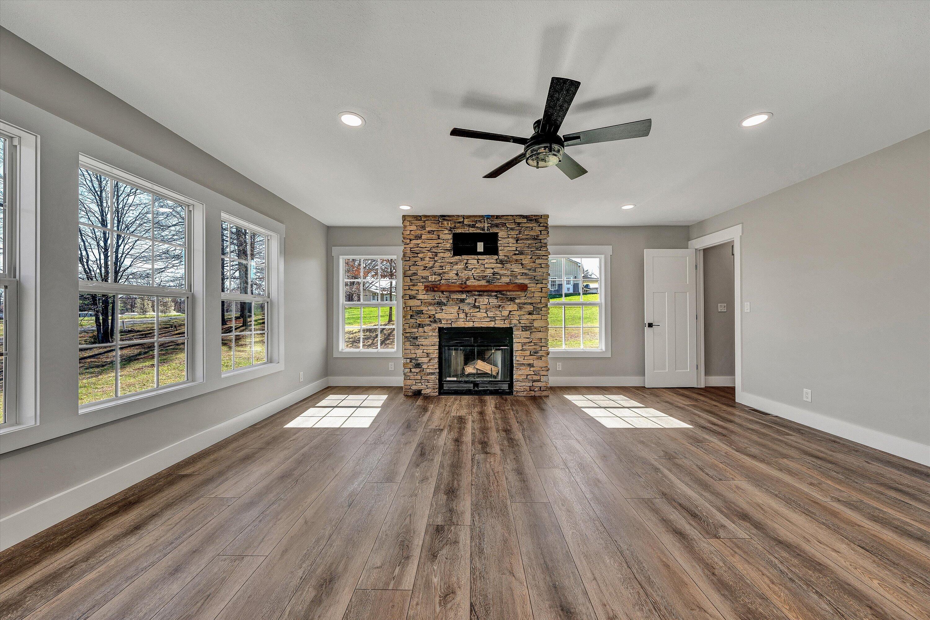 200 Surber Drive Moneta, VA 24121 - Photo 20 of 52 a view of an empty room with wooden floor fireplace and a window