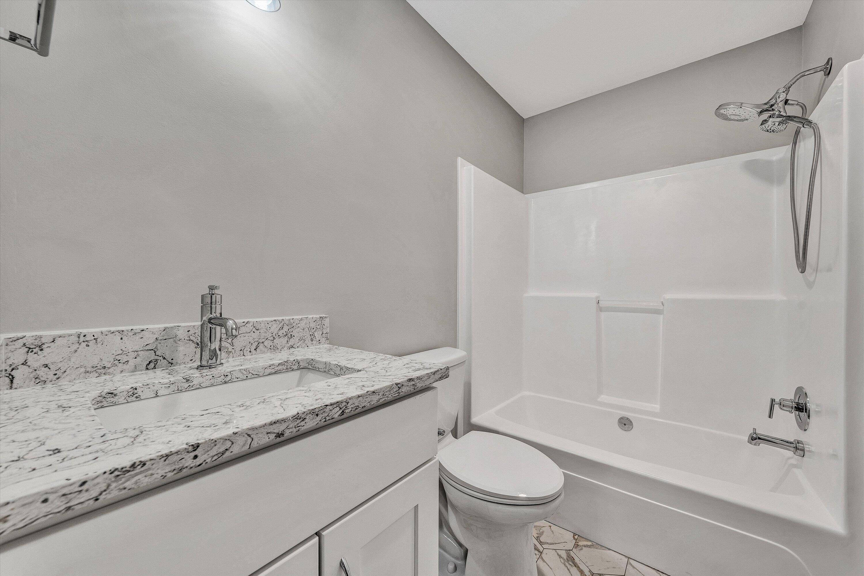 200 Surber Drive Moneta, VA 24121 - Photo 32 of 52 a bathroom with a granite countertop sink toilet and shower