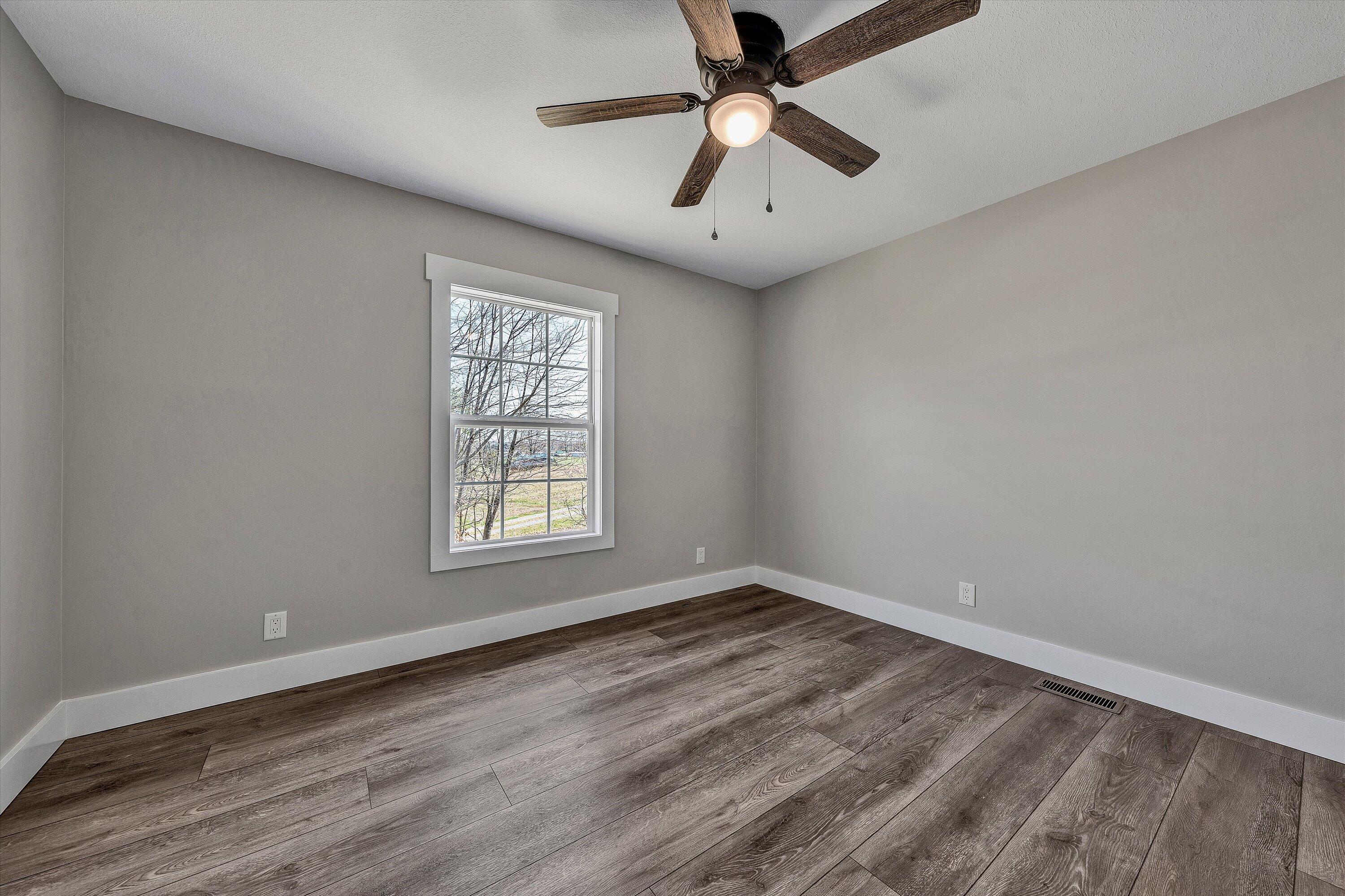 200 Surber Drive Moneta, VA 24121 - Photo 35 of 52 an empty room with wooden floor and windows