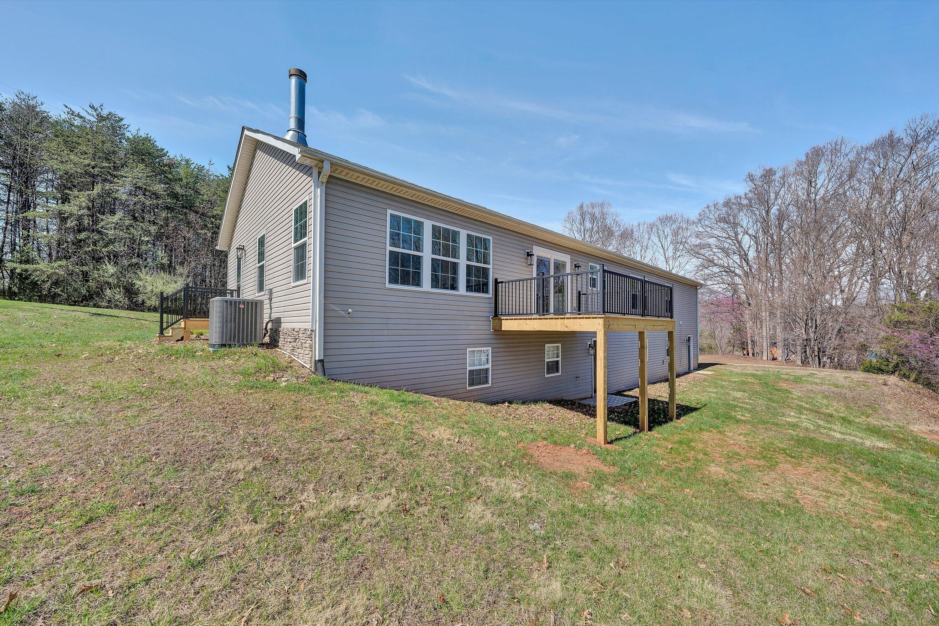200 Surber Drive Moneta, VA 24121 - Photo 43 of 52 a front view of house with yard and trees in the background