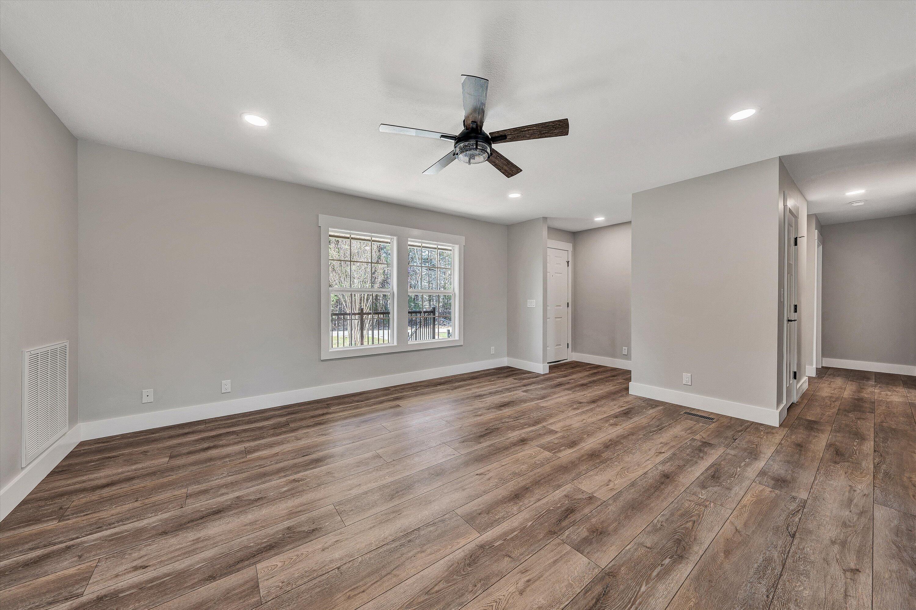 200 Surber Drive Moneta, VA 24121 - Photo 9 of 52 a view of an empty room with wooden floor and a window