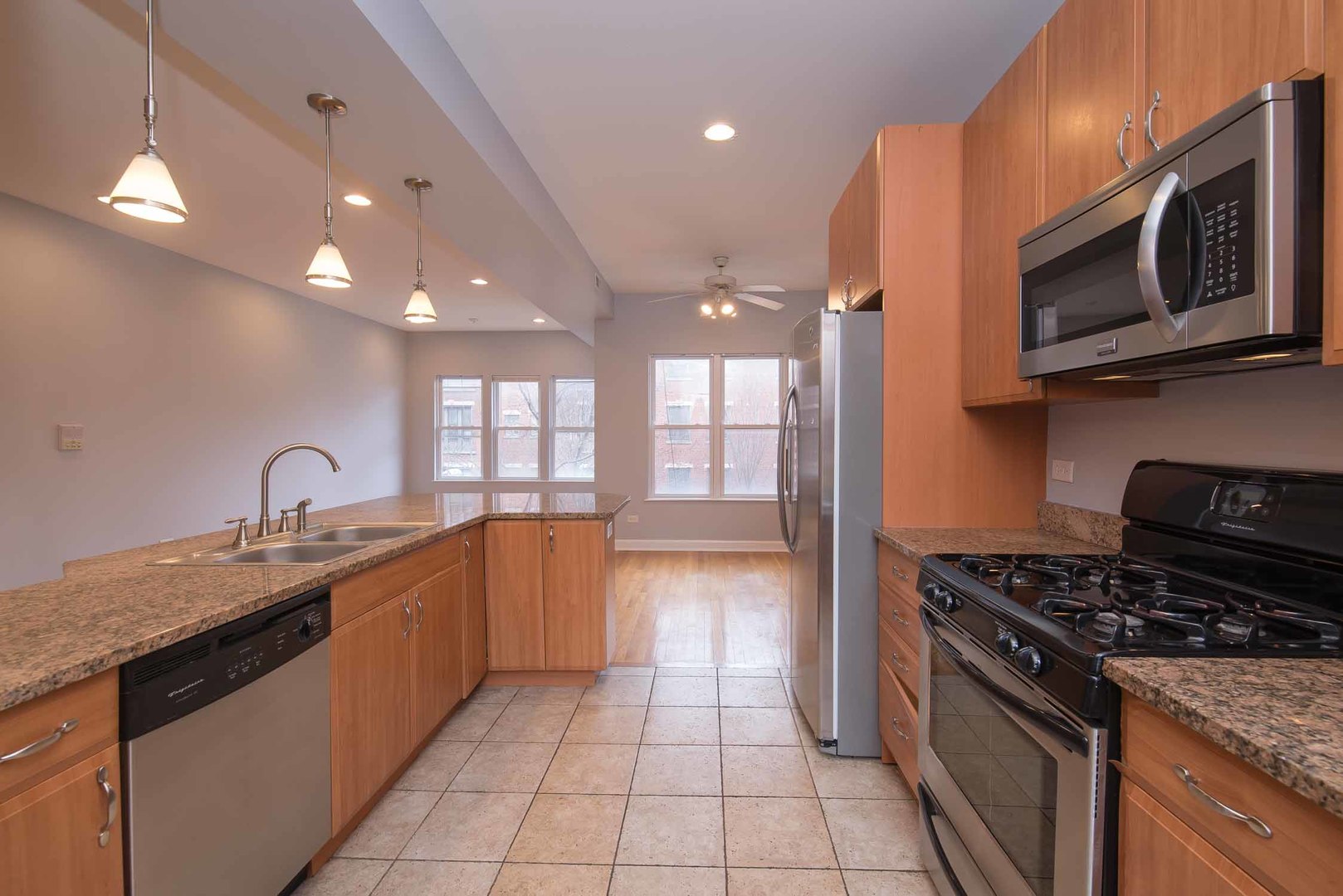 1628 West Juneway Terrace, Unit 2W Chicago, IL 60626 - Photo 14 of 23 a kitchen with stainless steel appliances granite countertop a sink and a stove