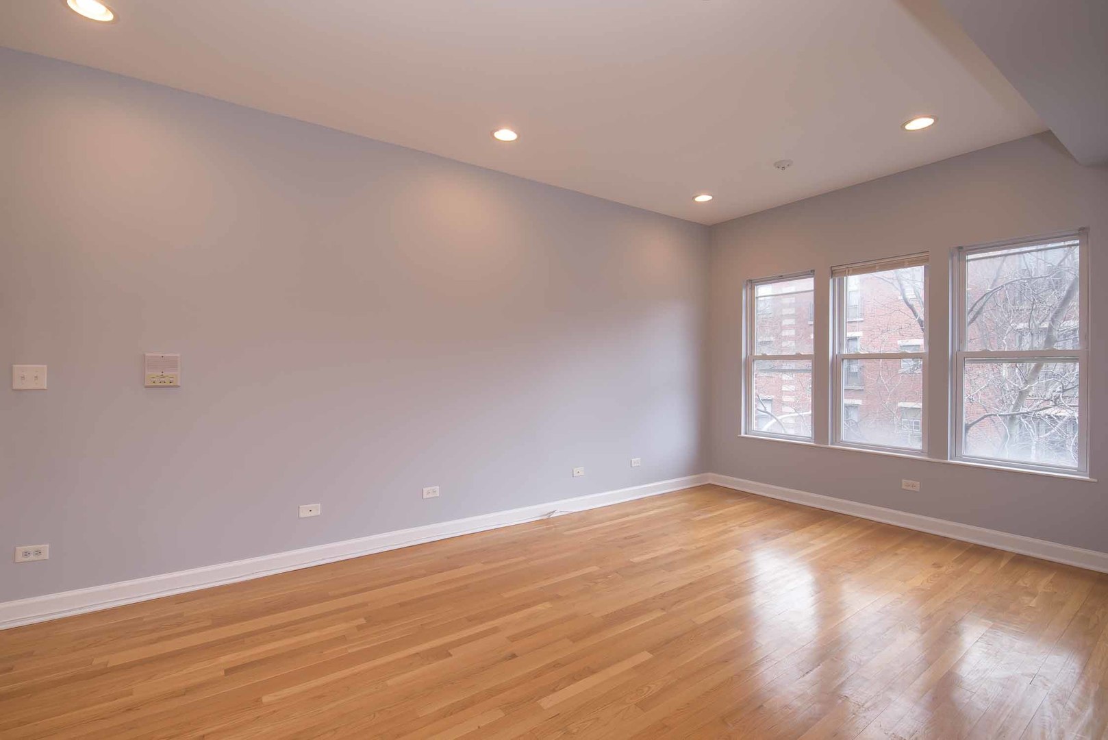 1628 West Juneway Terrace, Unit 2W Chicago, IL 60626 - Photo 7 of 23 wooden floor in an empty room with a window
