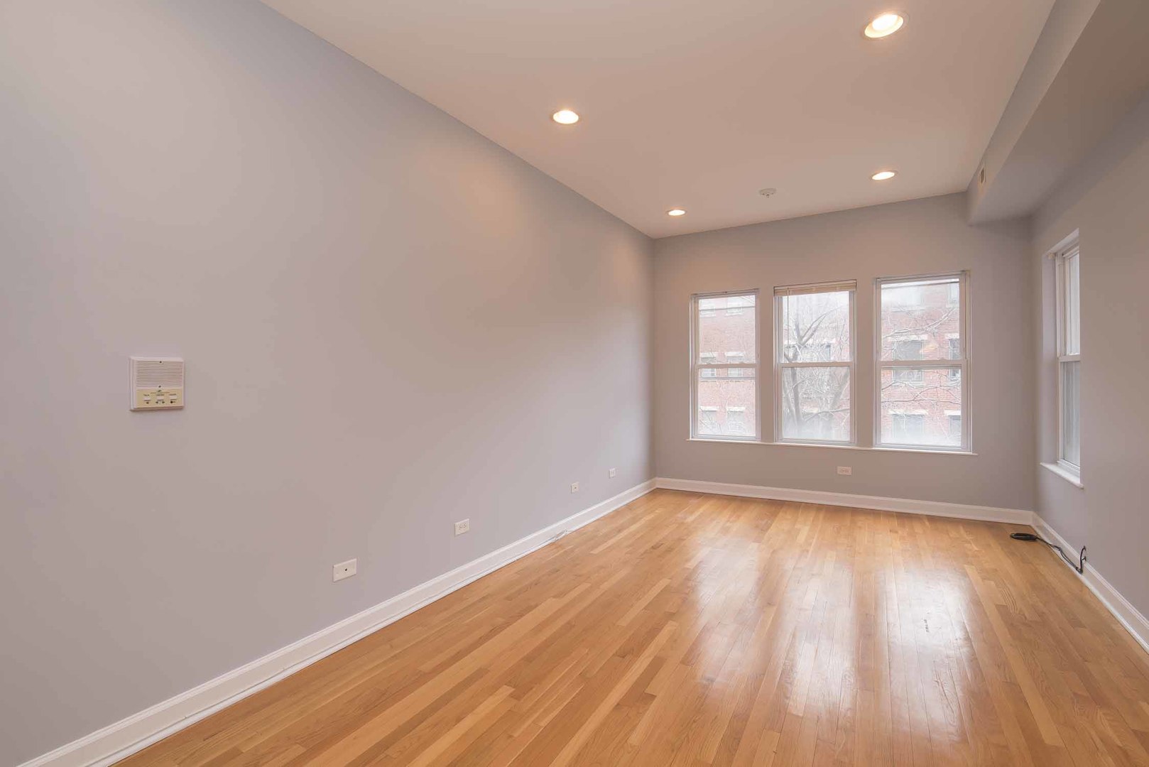 1628 West Juneway Terrace, Unit 2W Chicago, IL 60626 - Photo 8 of 23 a view of an empty room with wooden floor and a window