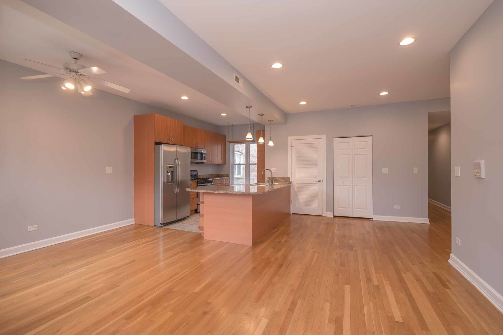1628 West Juneway Terrace, Unit 2W Chicago, IL 60626 - Photo 9 of 23 a view of kitchen with kitchen island wooden floor center island and stainless steel appliances