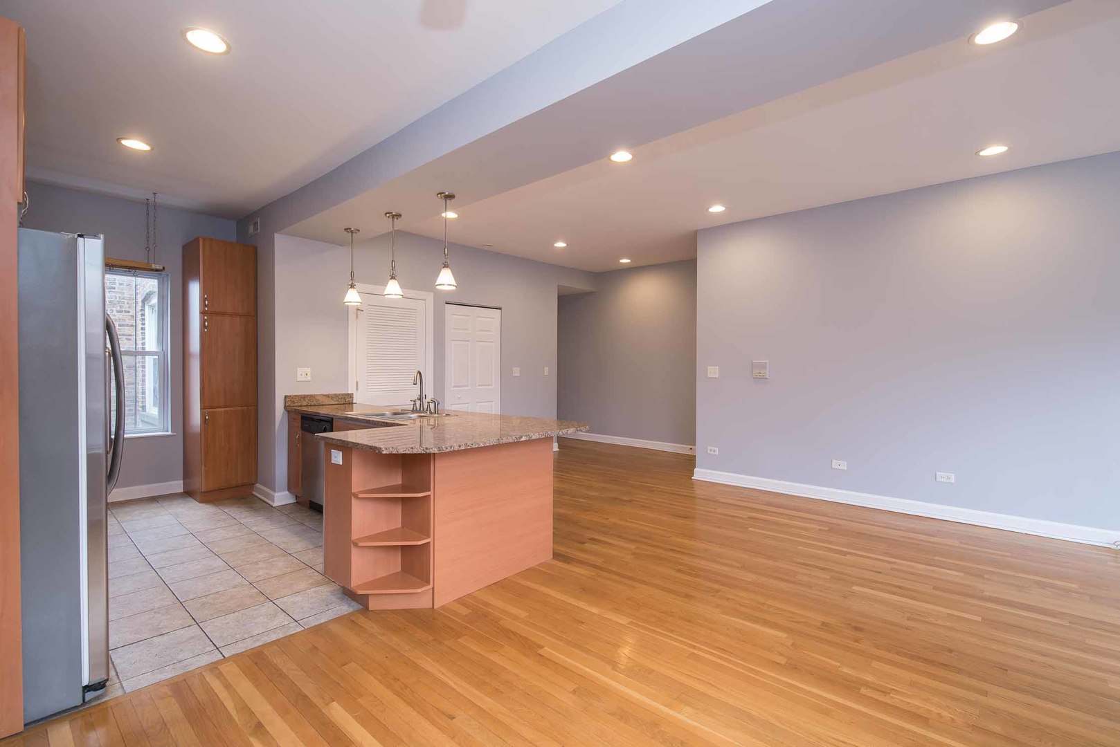 1628 West Juneway Terrace, Unit 2W Chicago, IL 60626 - Photo 10 of 23 a view of kitchen with kitchen island wooden floor center island and stainless steel appliances