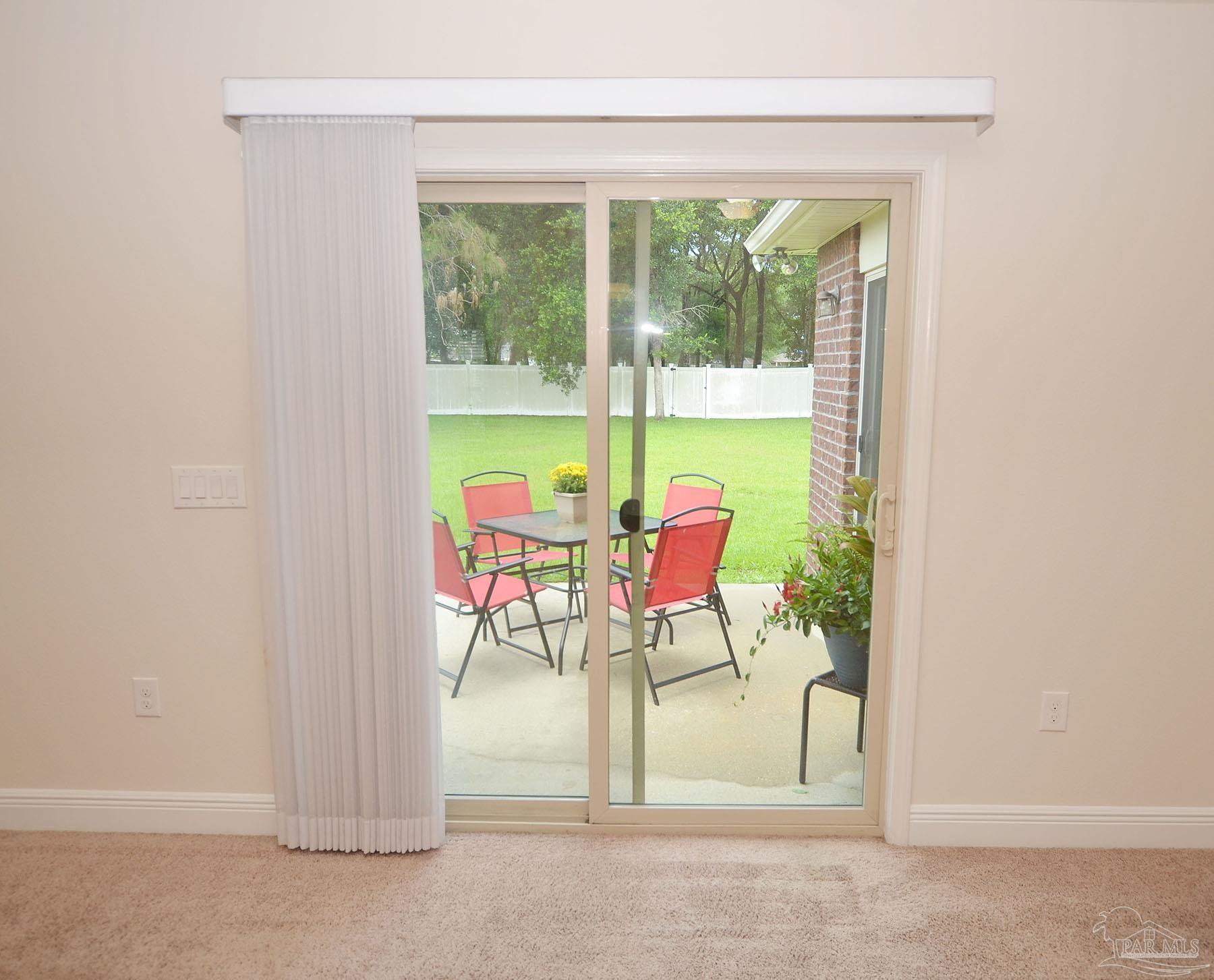 5709 Mill Stream Way Pace, FL 32571 - Photo 21 of 48 a view of a room that has a table and chairs in it
