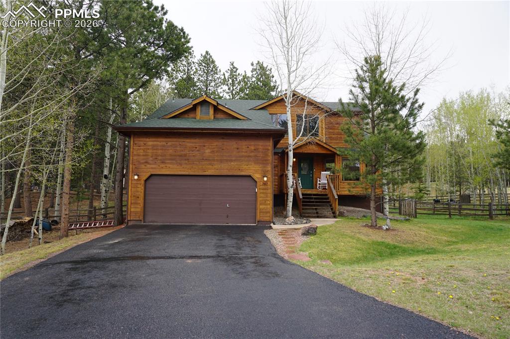 747 Pinon Ridge Drive Woodland Park, CO 80863 - Photo 1 of 32 a front view of a house with a yard