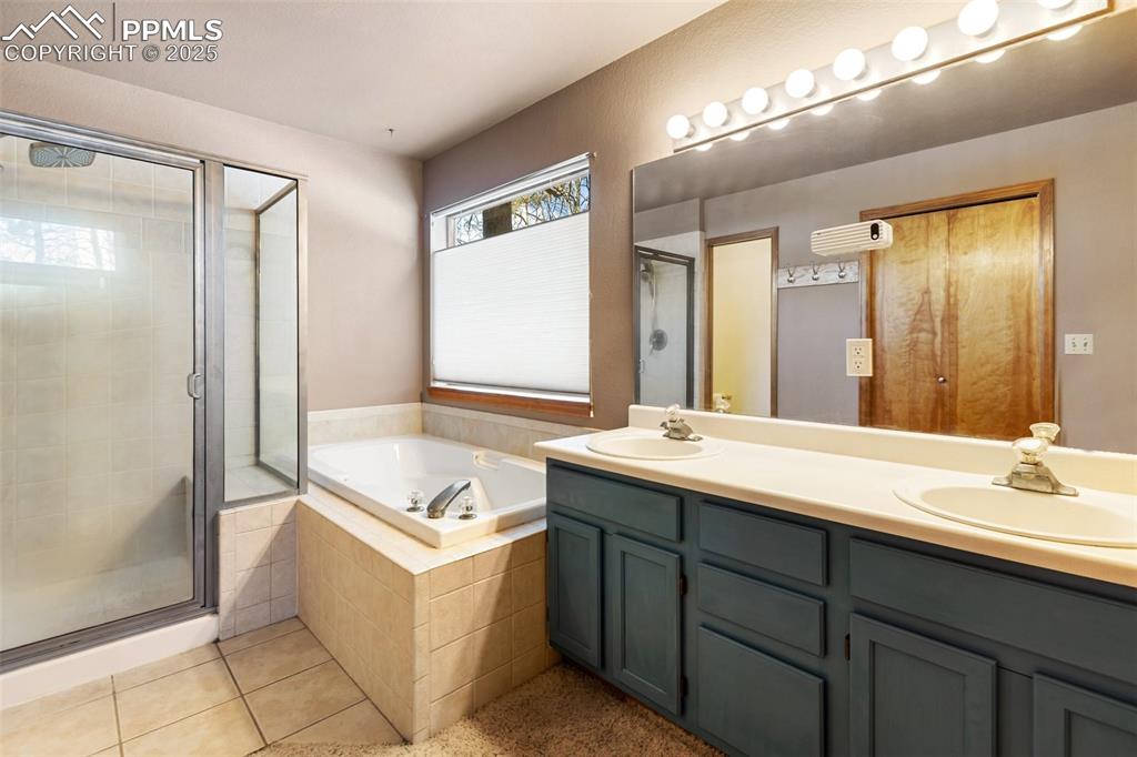 747 Pinon Ridge Drive Woodland Park, CO 80863 - Photo 13 of 32 a bathroom with a sink double vanity and a mirror