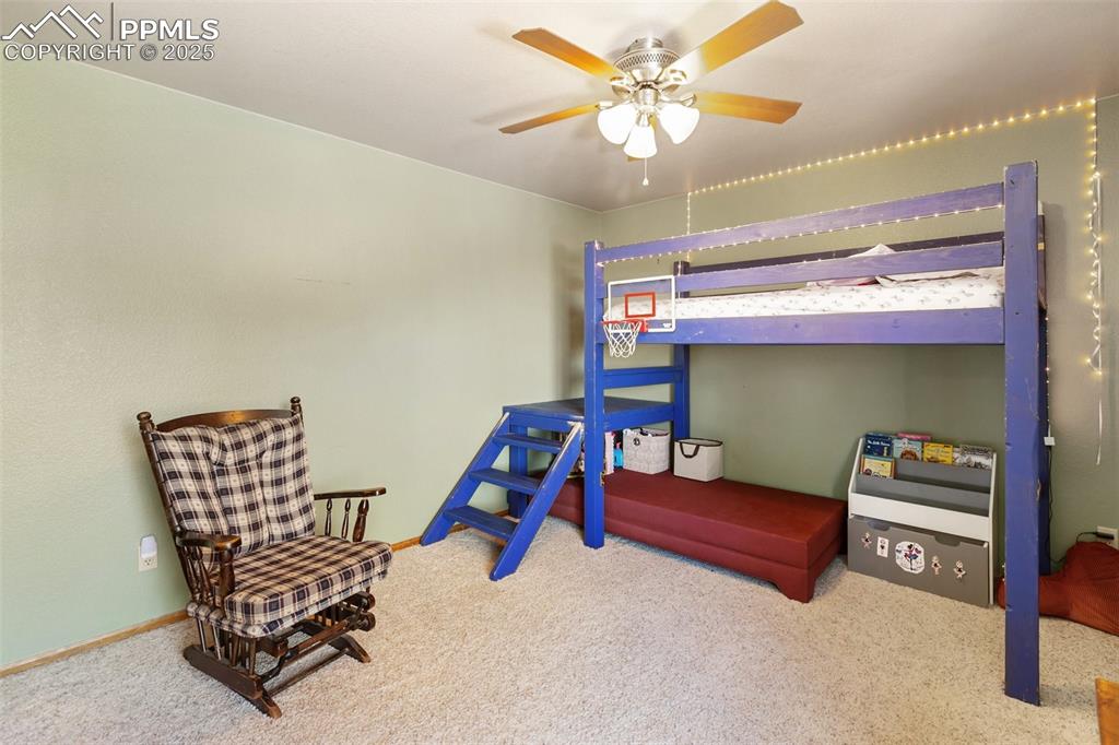 747 Pinon Ridge Drive Woodland Park, CO 80863 - Photo 15 of 32 a bedroom with furniture and a chandelier