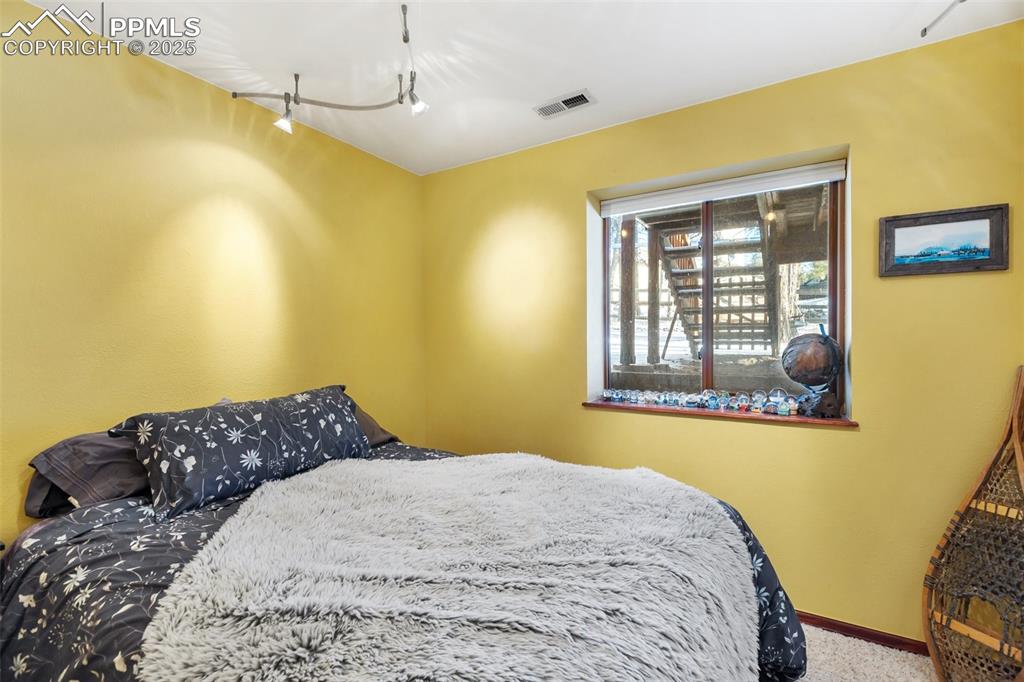 747 Pinon Ridge Drive Woodland Park, CO 80863 - Photo 22 of 32 a bedroom with a bed and a window