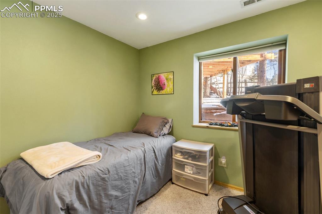 747 Pinon Ridge Drive Woodland Park, CO 80863 - Photo 23 of 32 a bedroom with a bed and a window
