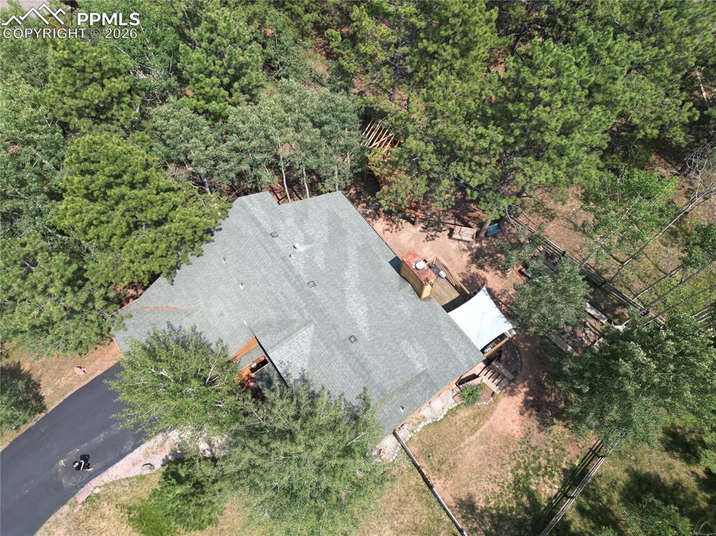 747 Pinon Ridge Drive Woodland Park, CO 80863 - Photo 30 of 32 an aerial view of a house with a yard and large trees