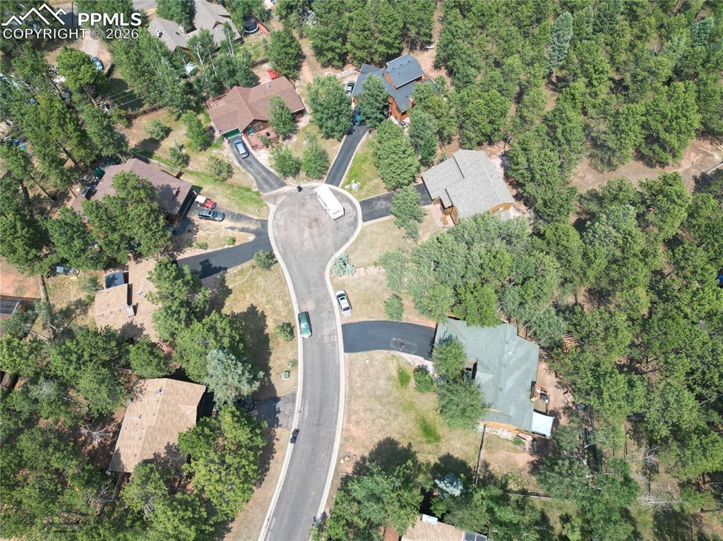 747 Pinon Ridge Drive Woodland Park, CO 80863 - Photo 31 of 32 an aerial view of a house with a yard and lake view