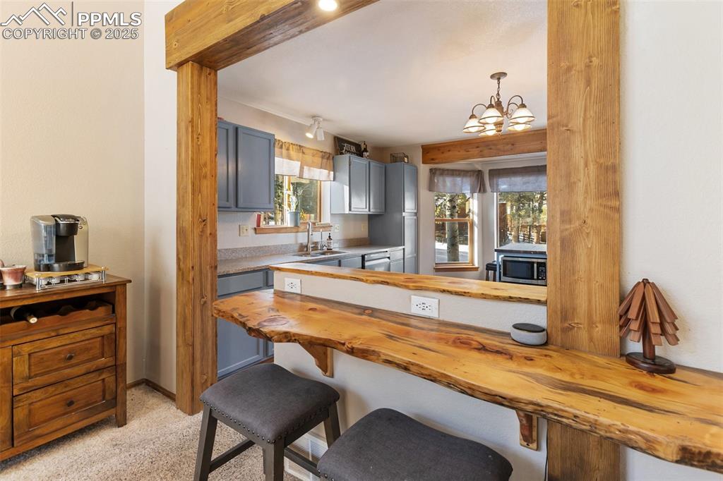 747 Pinon Ridge Drive Woodland Park, CO 80863 - Photo 6 of 32 a dining hall with granite countertop a stove and a sink