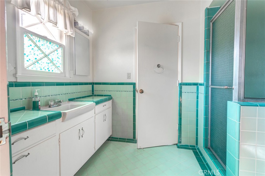 5211 Ocean View Boulevard La Canada Flintridge, CA 91011 - Photo 15 of 45 a spacious bathroom with a double vanity sink and a window