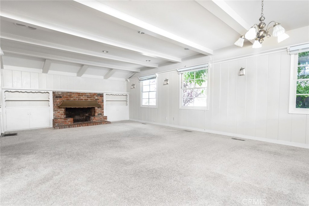 5211 Ocean View Boulevard La Canada Flintridge, CA 91011 - Photo 6 of 45 an empty room with windows and fireplace