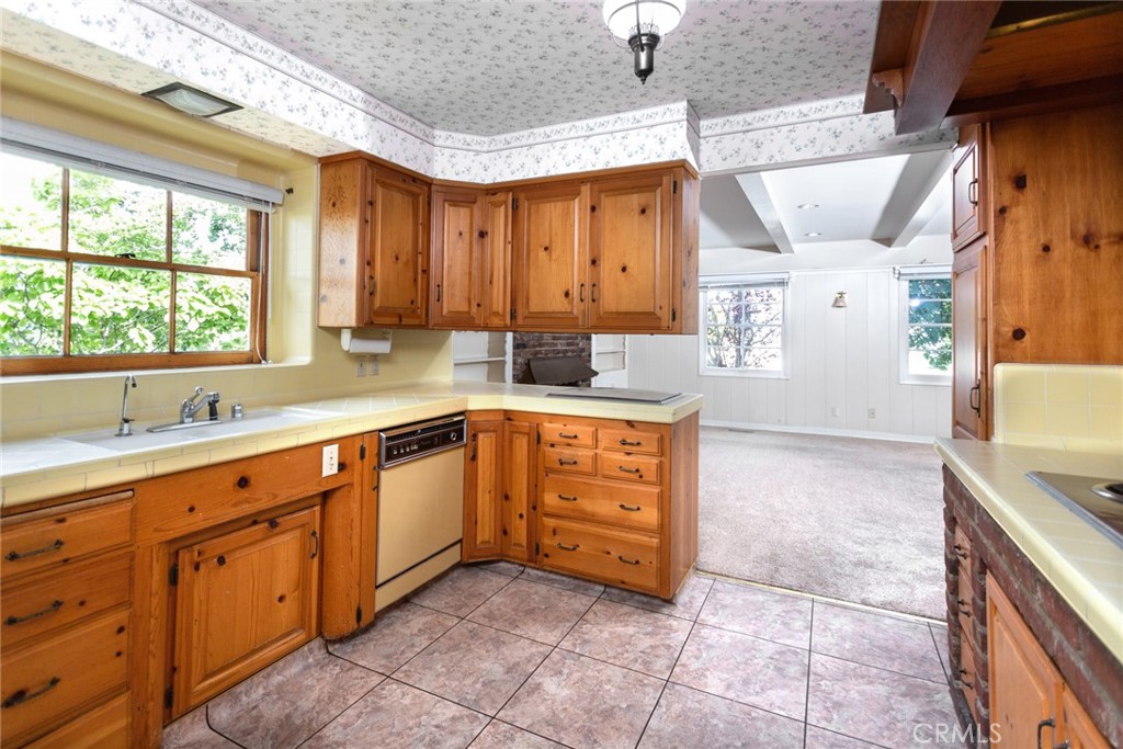 5211 Ocean View Boulevard La Canada Flintridge, CA 91011 - Photo 9 of 45 a large kitchen with a sink window and cabinets