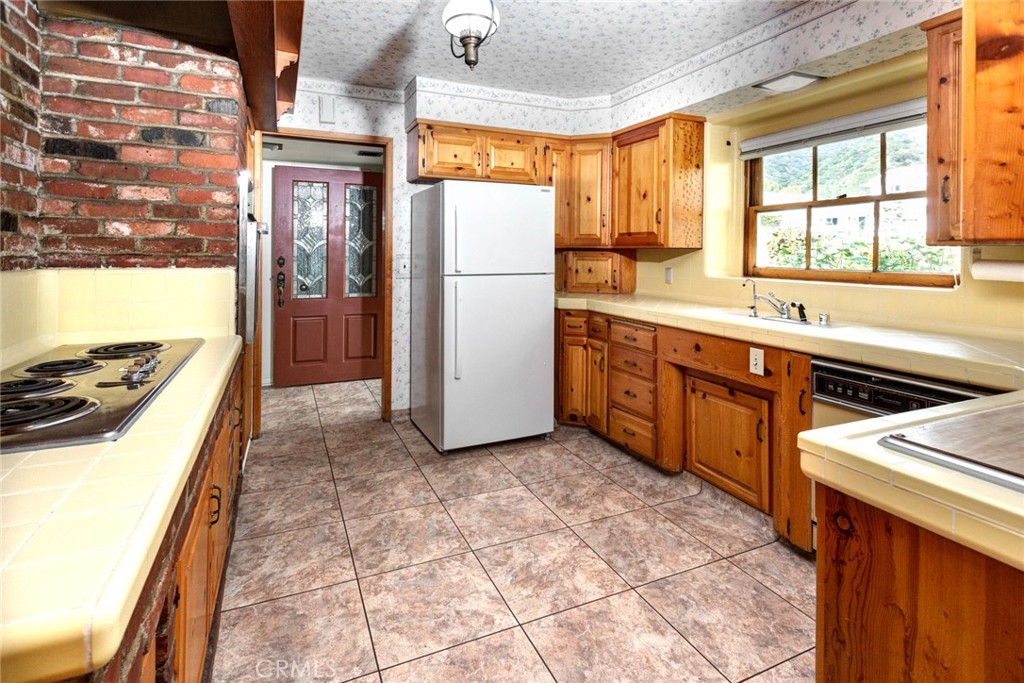 5211 Ocean View Boulevard La Canada Flintridge, CA 91011 - Photo 10 of 45 a kitchen with stainless steel appliances granite countertop a refrigerator and a stove