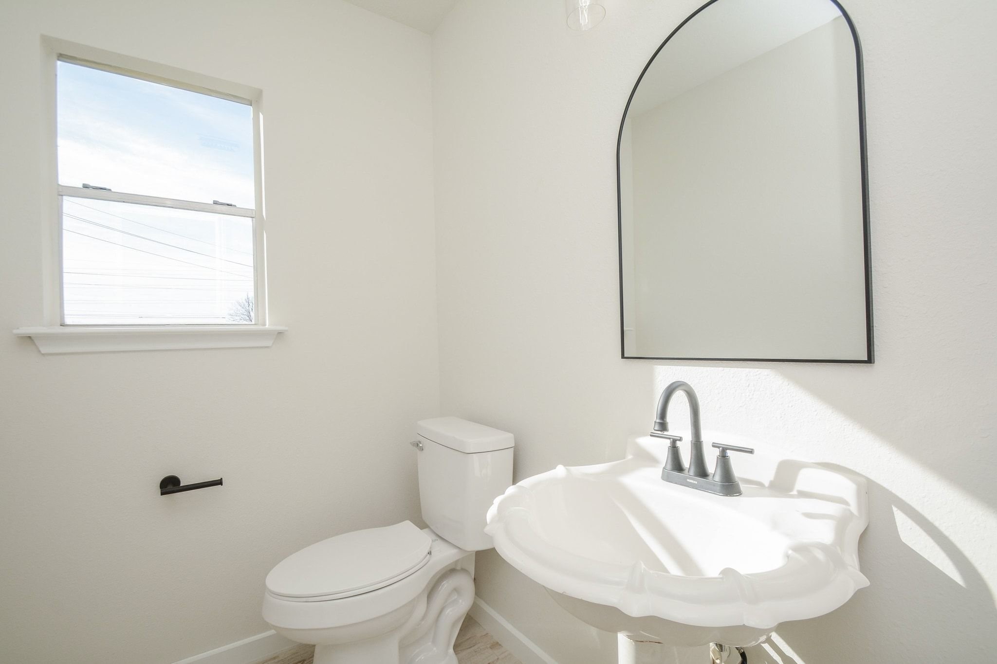 4903 South Lazy Ridge Drive Houston, TX 77053 - Photo 12 of 29 a bathroom with a toilet sink and mirror